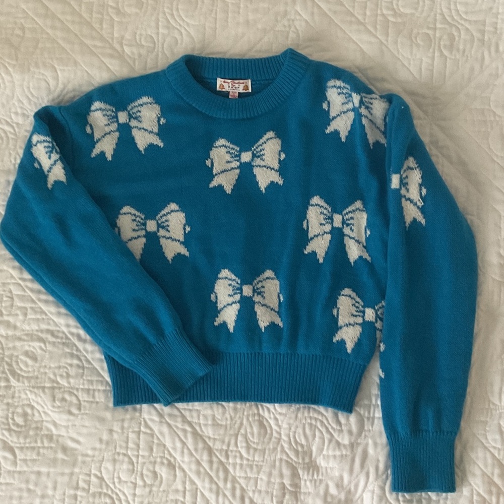 Poof! Teal Sweater with White Bow Design